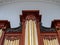 Upward view of a massive oak 19th century pipe organ