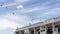 Upward view of old building under beautiful white fluffy cloud formation on vivid blue sky in a sunny day