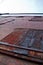 Upward View of Weathered Brick Facade with Rusty Metal Door in Urban Louisville