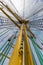 Upwards view of a yellow ship mast