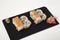 Uramaki with salmon, avocado and cheese on white background