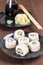 Uramaki sushi with carrot, cucumber, surimi and roasted white se