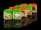 Uramaki Sushi roll with eel, cheese, omelet and green and orange tobiko caviar isolated on black background with