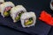 Uramaki sushi rolls with surimi on black slate