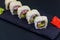Uramaki sushi rolls with surimi on black slate