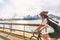 Urban biking girl riding road bike cycling in the city. Happy cyclist with downtown background by the St Lawrence river