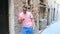 Urban caucasian boy walking in street at Europe. Young man with phone outdoors