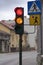 Urban city traffic lights with pedesetrian signs cross the main street.