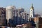 Urban contrasts of the city of Kiev. Modern residential buildings and bell tower of St. Sophia Cathedral