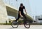 Urban cycling, trick and man on bicycle for sports, balance and action in city street. Cool male person, cycle stunt and