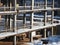 urban development. construction site in winter during the day. workers in uniform prepare the scaffolding