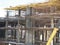 urban development. construction site in winter during the day. workers in uniform prepare the scaffolding