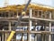 urban development. construction site in winter during the day. workers in uniform prepare the scaffolding