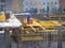 urban development. construction site in winter during the day. workers in uniform prepare the scaffolding