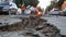 Urban earthquake aftermath with damaged road and emergency response