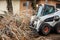 Urban emergency service removes a fallen tree on a road with special equipment tractor