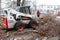 Urban emergency service removes a fallen tree on a road with special equipment tractor