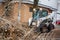 Urban emergency service removes a fallen tree on a road with special equipment tractor