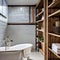Urban Farmhouse Bathroom: An urban farmhouse-style bathroom with a clawfoot bathtub, subway tiles, and repurposed wooden shelves