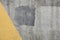 Urban grey cement wall with bright yellow color corner