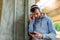 Urban handsome man jogger choosing music on before running