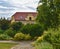 Urban historic background. Urban romantic park. Soft colors. Flowers and building on background. Selective focus.