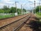 Urban industrial landscape railroad tracks runs to perspective on sunny summer day