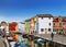 Urban landscape on the island of Burano with colorful buildings and tourists on the streets, Venice