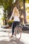 Urban leisure - young woman and bike in city