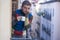 Urban lifestyle emotional portrait of young attractive man sad and depressed at home balcony drinking coffee cup suffering