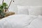 Urban loft bedroom white bed linen and creative nighstand with plants