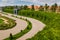 Urban nature: privy garden in majestic Schonbrunn palace, Vienna Austria against orange houses and dramatic sky