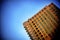 Urban orange cityscape buildings against blue sky