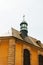 Urban ornated church cross on top church roof