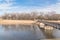 Urban park bare tree, altocumulus cloud, fountain lake in Texas, USA