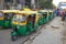 Urban parking green yellow Indian rickshaw taxi