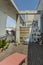 Urban penthouse terrace with acacia wood floor decorated with many plants, concrete structure