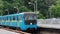 Urban public transport, travel, infrastructure, metropolis concept - a blue and yellow metro train passes through a