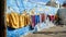 urban scene with multi colored laundry drying in front of a painted old town wall, Azemmour, Morocco