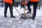 Urban service workers in uniform clean snow