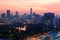 Urban skyline of Bangkok City at sunset, with famous landmark Mahanakhon Tower amid modern high rise buildings