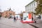 Urban stret of the Novi Sad city on the rainy day with people walking and billboards for celebration of 100 years of victory in th