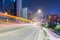 Urban traffic night scene with light trails on overpass