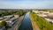 Urban Tranquility: Canal Flanked by Greenery and Industry