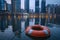 Urban tranquility: A lifebuoy gently floating in an urban landscape, framed by the modern silhouette of the city skyline