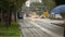 Urban transportation, view of blue tram and cars driving on the road, evening