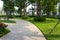 Urban walking road among green tree in modern apartment buildings in big city