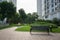 Urban walking road among green tree in modern apartment buildings in big city