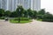 Urban walking road among green tree in modern apartment buildings in big city