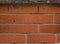 Urban wall reddish decorative bricks texture outside a building.